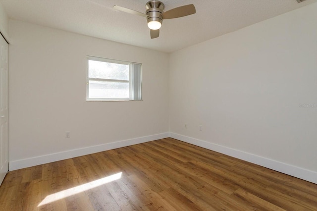 empty room featuring hardwood / wood-style flooring and ceiling fan