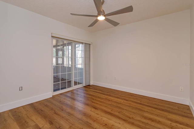 spare room with hardwood / wood-style flooring, ceiling fan, and a textured ceiling