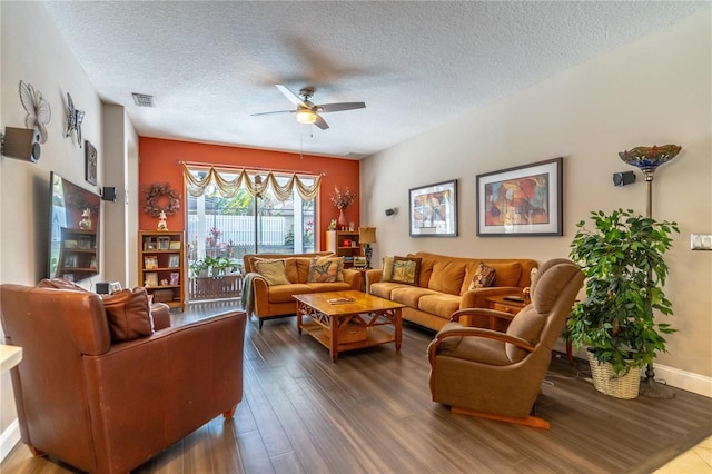 living room featuring wood-type flooring, a textured ceiling, and ceiling fan