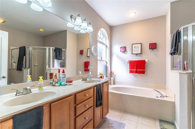 bathroom with shower with separate bathtub, tile patterned floors, a textured ceiling, and vanity