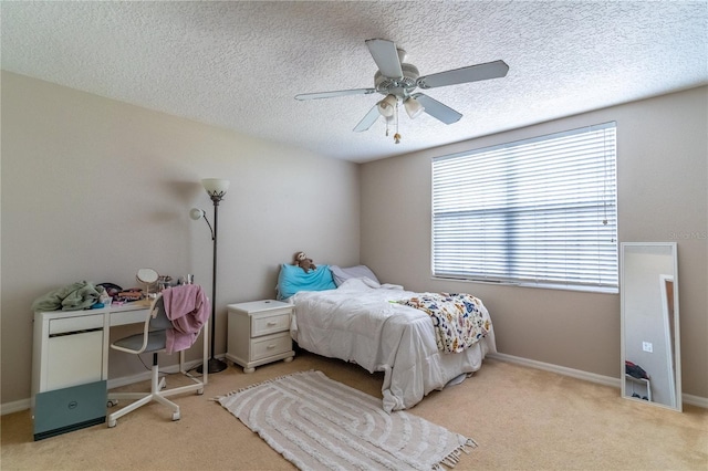 carpeted bedroom featuring a textured ceiling and ceiling fan