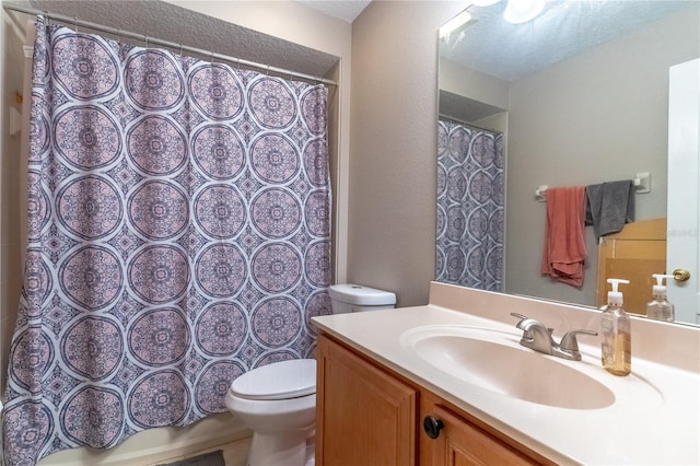 bathroom with walk in shower, vanity, and toilet