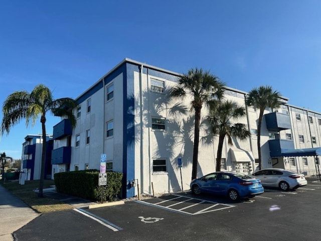 view of property featuring uncovered parking