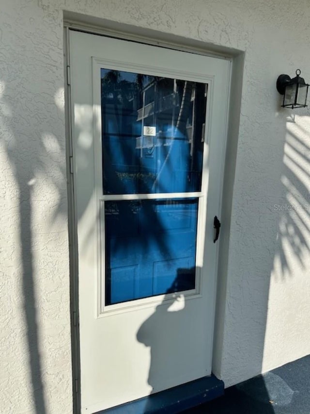 entrance to property with stucco siding