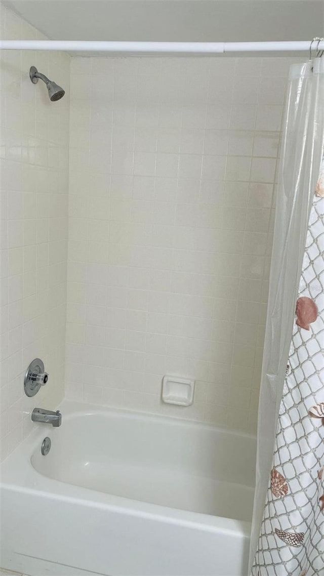 bathroom featuring shower / tub combo with curtain