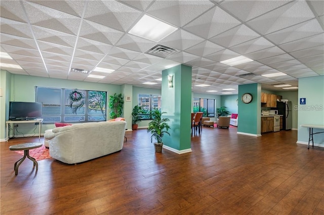 living room with a paneled ceiling and hardwood / wood-style floors