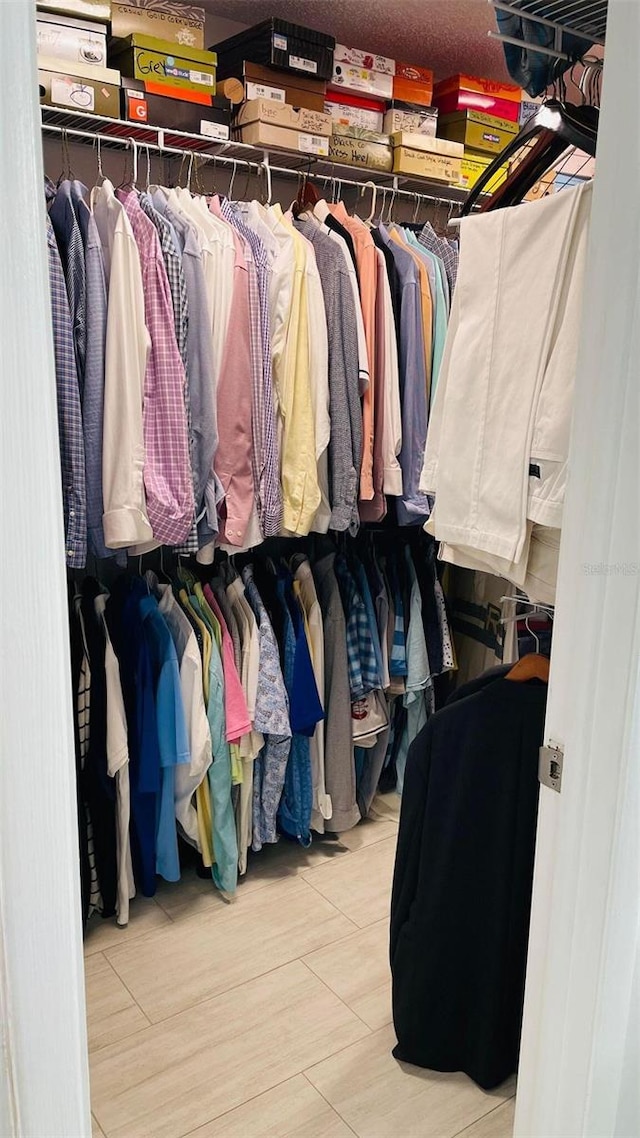 walk in closet featuring wood finished floors