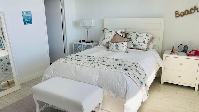 bedroom featuring baseboards and light wood-type flooring