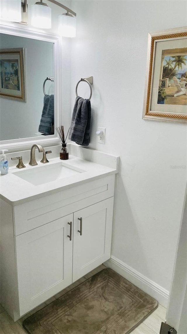 bathroom with baseboards and vanity