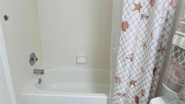 bathroom featuring shower / bathtub combination with curtain