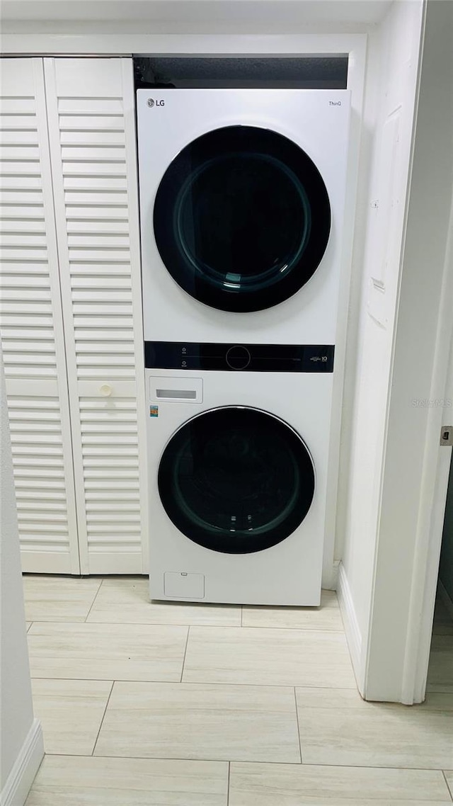 laundry area with laundry area and stacked washer / dryer