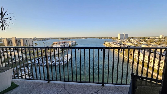 balcony with a water view, central AC, and a view of city