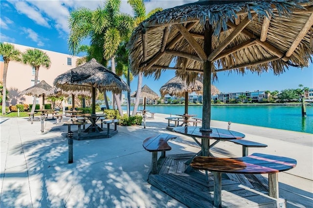 view of swimming pool with a gazebo, a water view, and a patio area