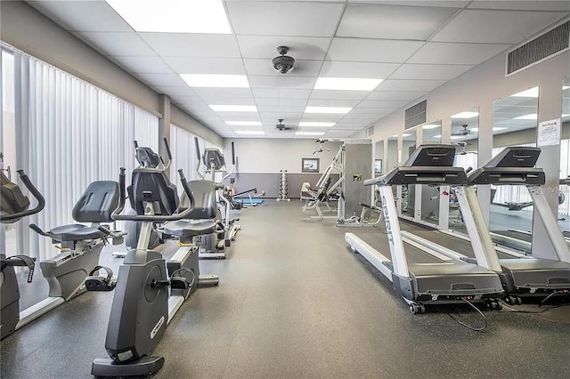 exercise room with visible vents and a paneled ceiling