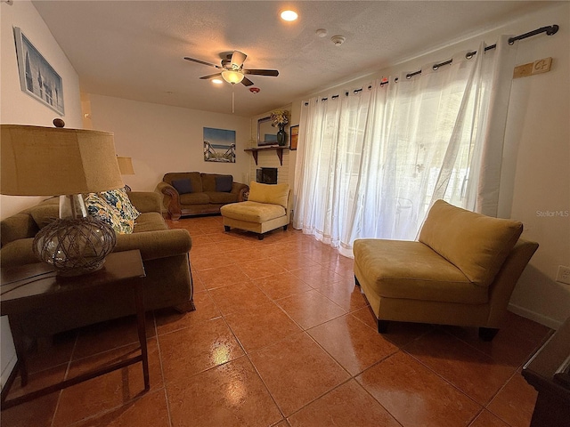 tiled living room with ceiling fan