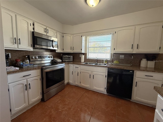 kitchen featuring appliances with stainless steel finishes, sink, decorative backsplash, and white cabinets