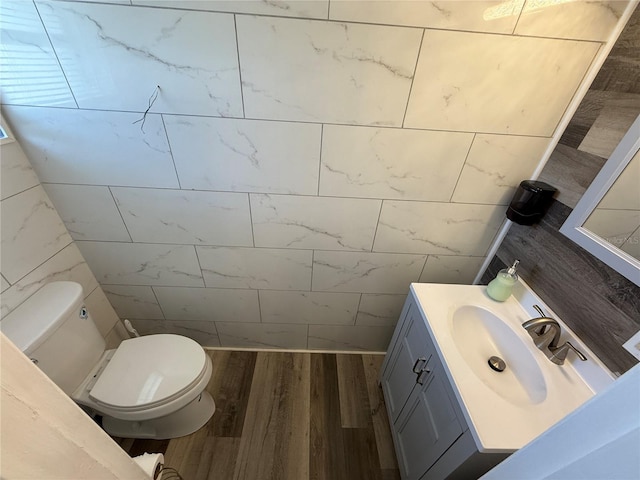 bathroom featuring vanity, wood-type flooring, and toilet