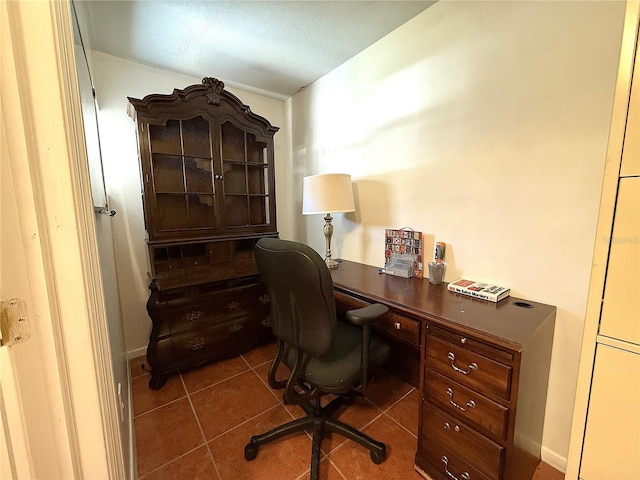 office with dark tile patterned flooring and built in desk