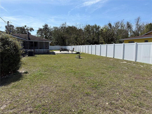 view of yard with a sunroom and central air condition unit