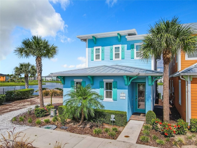 view of front of house with a water view