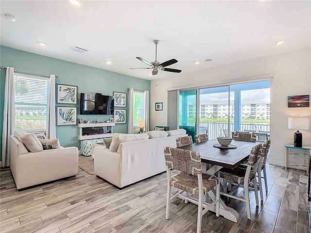 living room with ceiling fan and light hardwood / wood-style floors