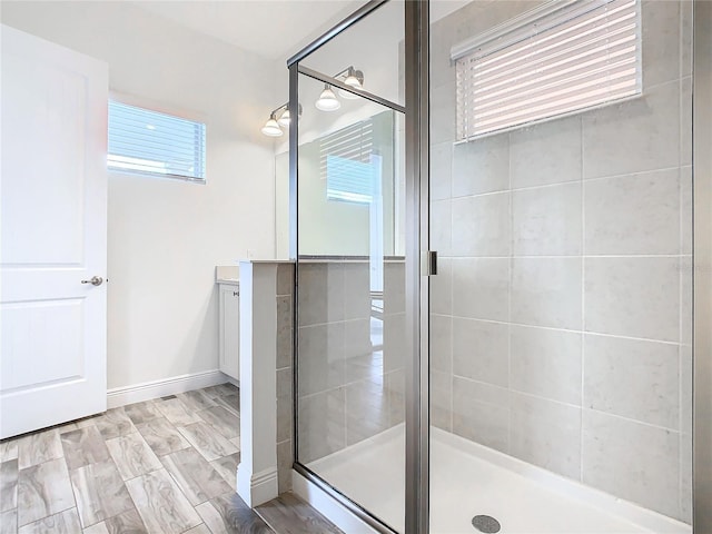 bathroom with walk in shower and vanity