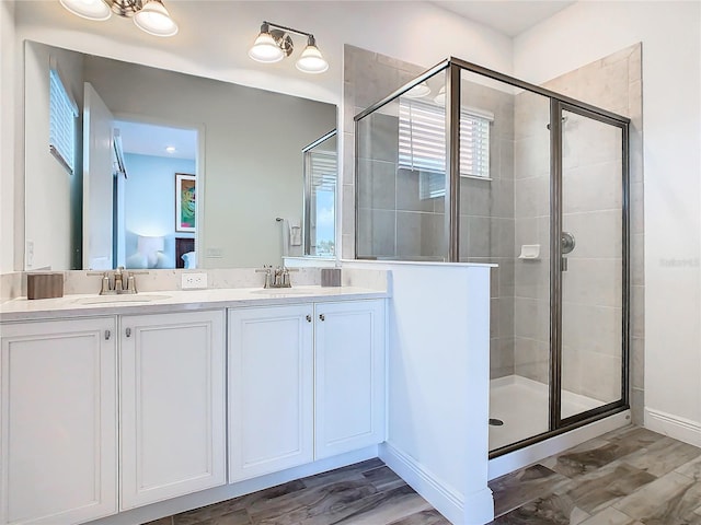 bathroom featuring a shower with door, wood-type flooring, and vanity