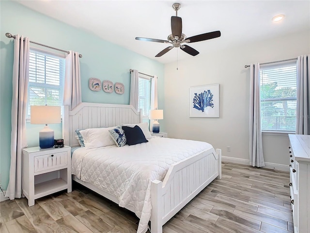 bedroom featuring ceiling fan and light hardwood / wood-style flooring