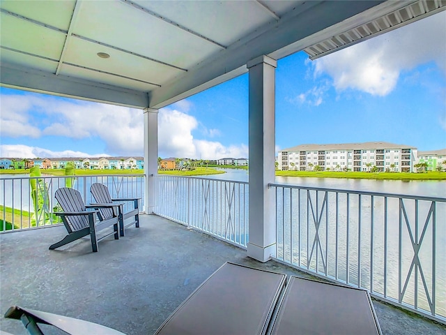 view of patio / terrace featuring a balcony and a water view