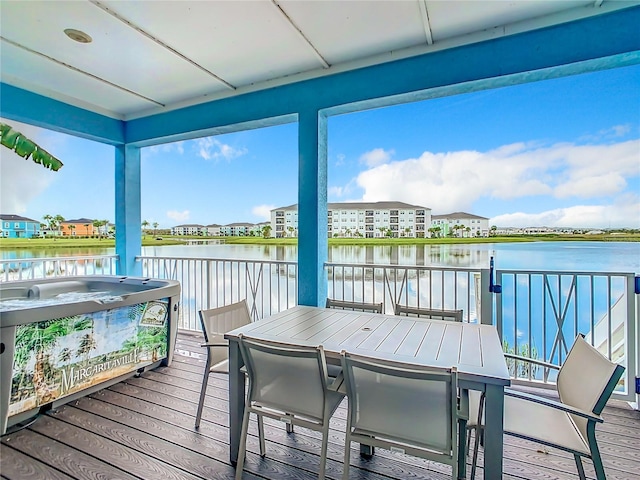 sunroom / solarium featuring a water view