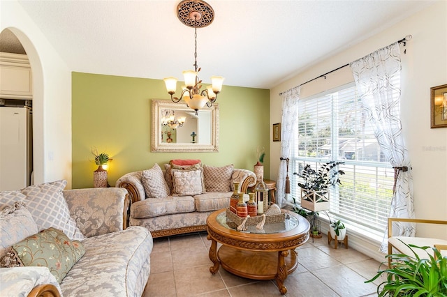 living room featuring light tile patterned flooring, a chandelier, and a textured ceiling