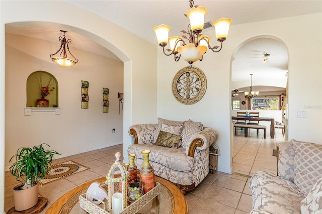 tiled living room with a textured ceiling and a notable chandelier