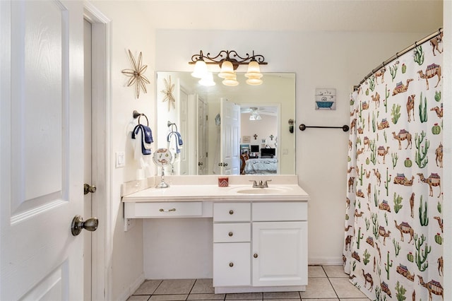 bathroom with tile patterned flooring, vanity, and walk in shower