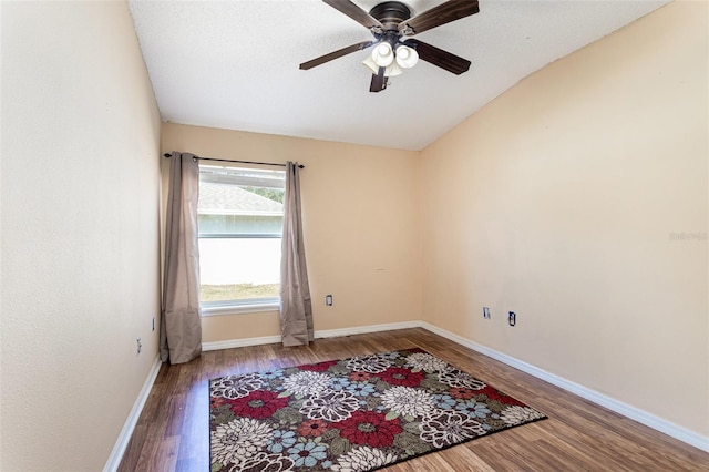 spare room featuring lofted ceiling, hardwood / wood-style floors, and ceiling fan