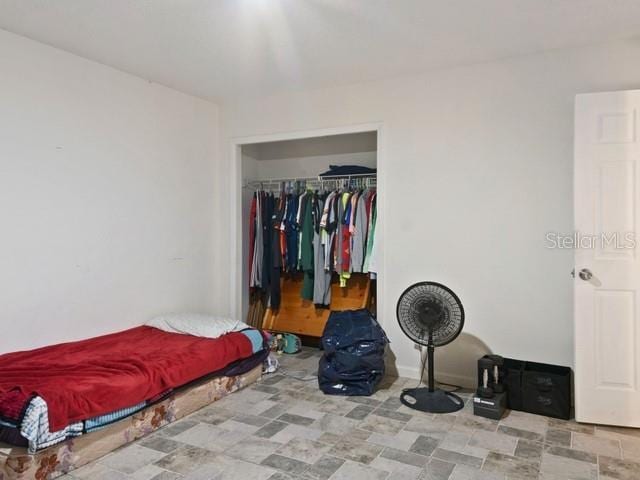 bedroom with a walk in closet and a closet