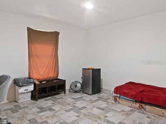 bedroom featuring fridge