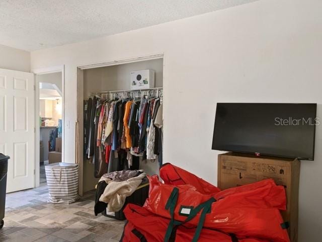 bedroom featuring a closet and a textured ceiling