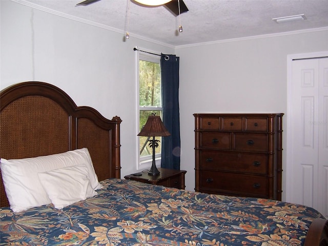 bedroom featuring ornamental molding, ceiling fan, and a textured ceiling