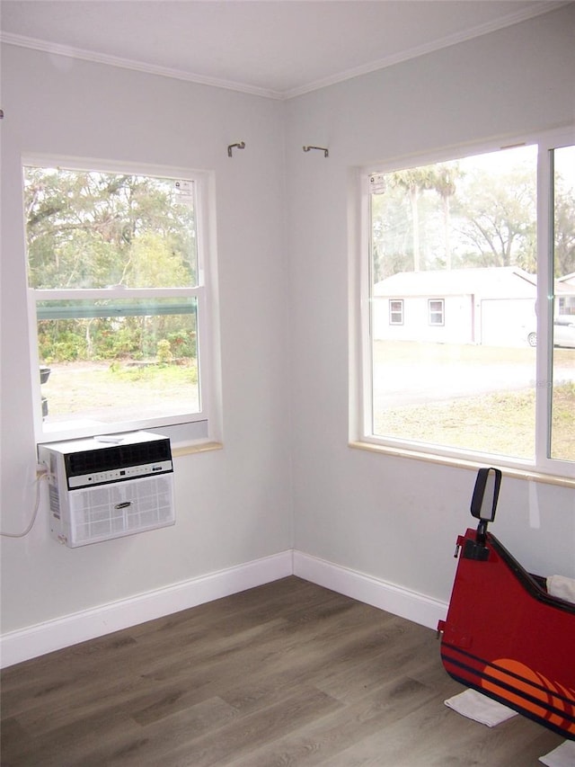 spare room featuring crown molding, dark hardwood / wood-style floors, and a wall mounted AC