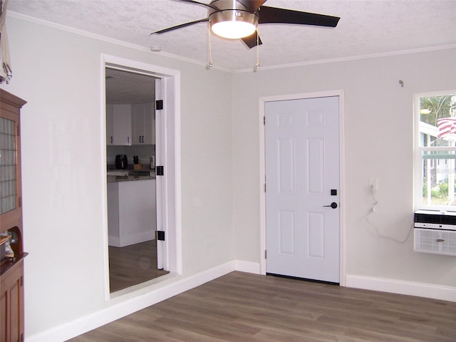 interior space with crown molding, dark wood-type flooring, ceiling fan, and a textured ceiling