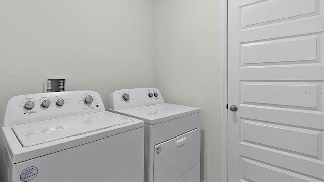 clothes washing area with washing machine and dryer