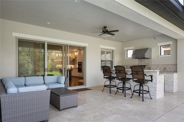 view of patio with an outdoor living space, exterior bar, and ceiling fan