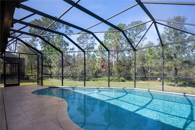 view of swimming pool with a lanai and a patio area