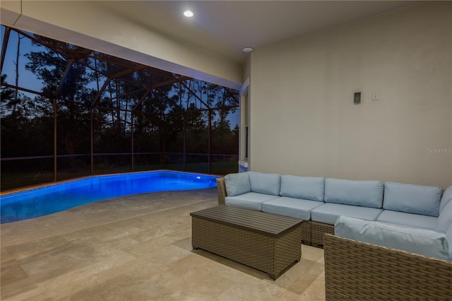 pool at dusk with an outdoor living space, a lanai, and a patio area