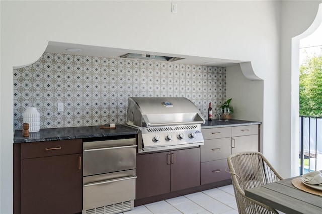 view of patio featuring an outdoor kitchen and a grill