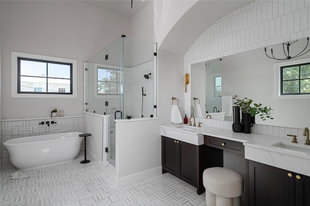 bathroom with vanity and separate shower and tub