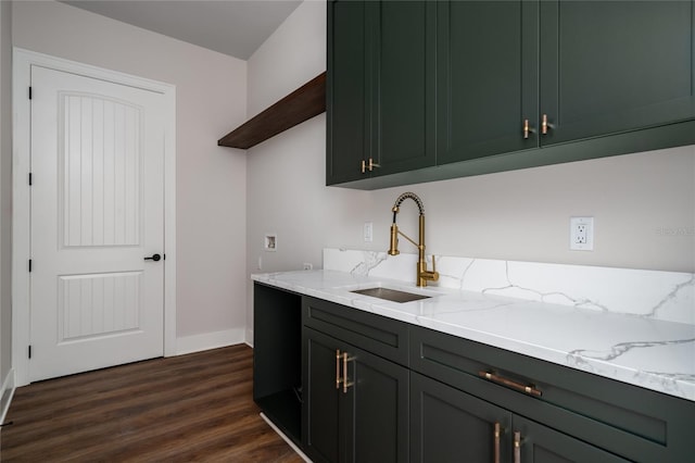 kitchen with dark wood-type flooring, black dishwasher, light stone countertops, and sink