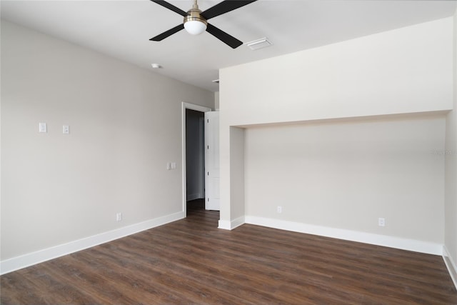 empty room with dark hardwood / wood-style floors and ceiling fan