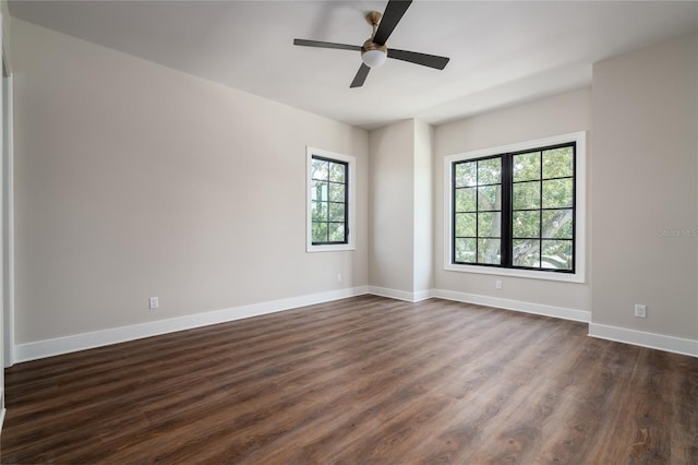 empty room with dark wood-type flooring and ceiling fan