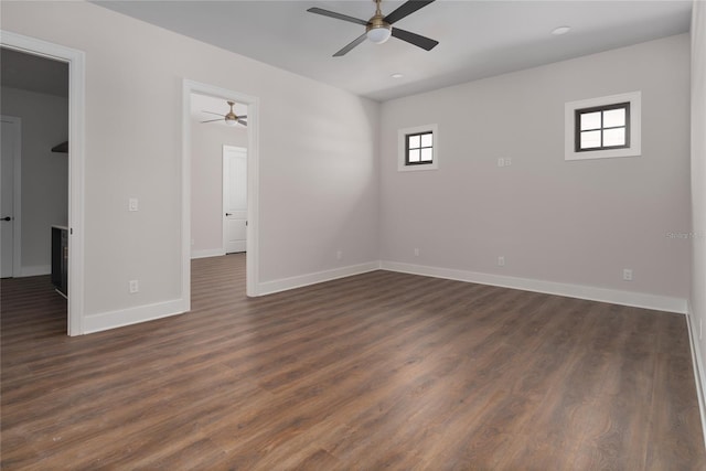 unfurnished room with dark wood-type flooring and ceiling fan